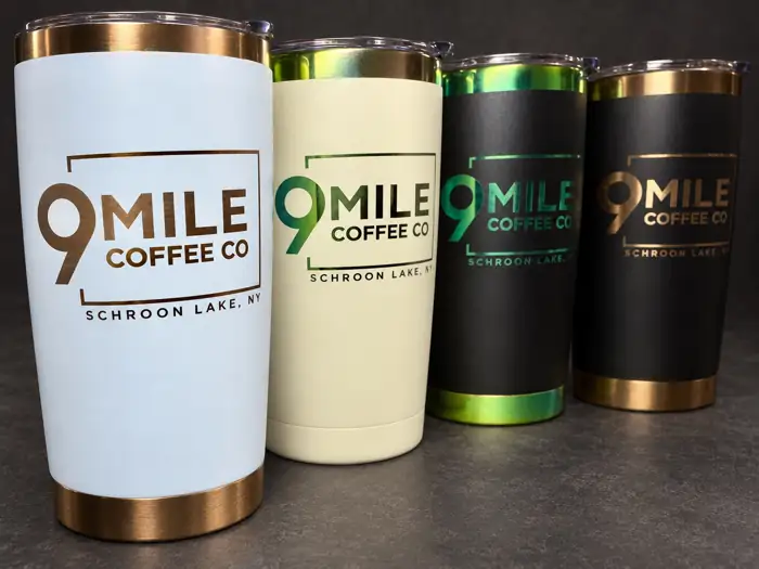Four engraved 9 Mile Coffee Co tumblers in different finishes