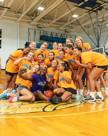 Tay Fisher basketball camp group wearing their yellow camp shirts